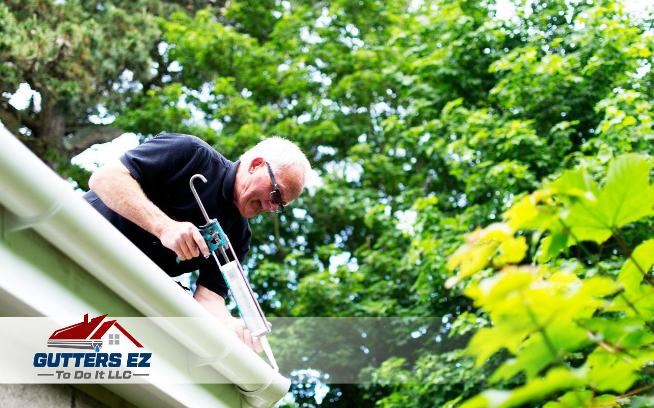 Applying sealant to fix gutter leaks.